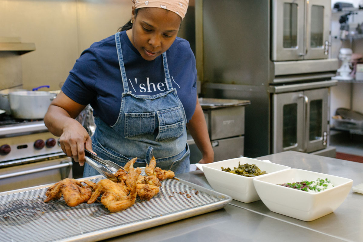 La Cocina alum chef Fernay McPherson works on plating fried chicken with red beans and rice  